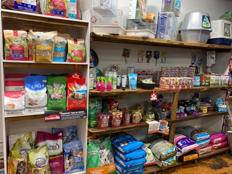 shelves lined with small animal food, treats & toys