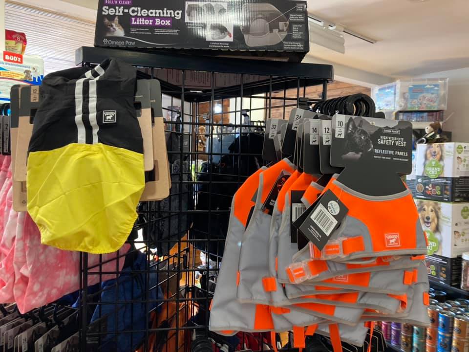 display of dog jackets with a self-cleaning litter box on top